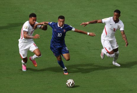 Kylian Mbappe #10 of France controls the ball against Ezri Konsa #2 and Morgan Rogers #17